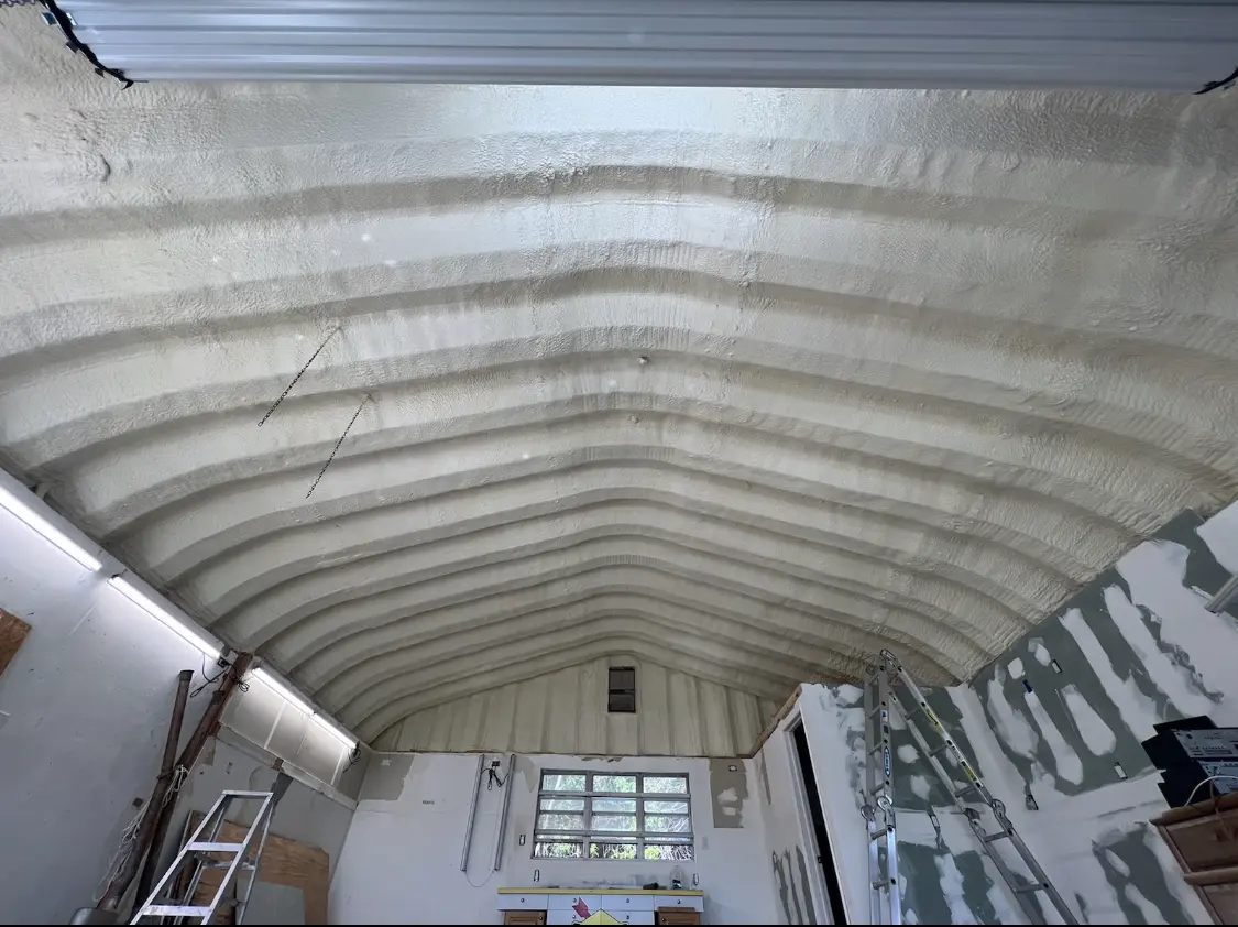 Spray polyurethane foam applied to the underside of a metal roof deck in Southport